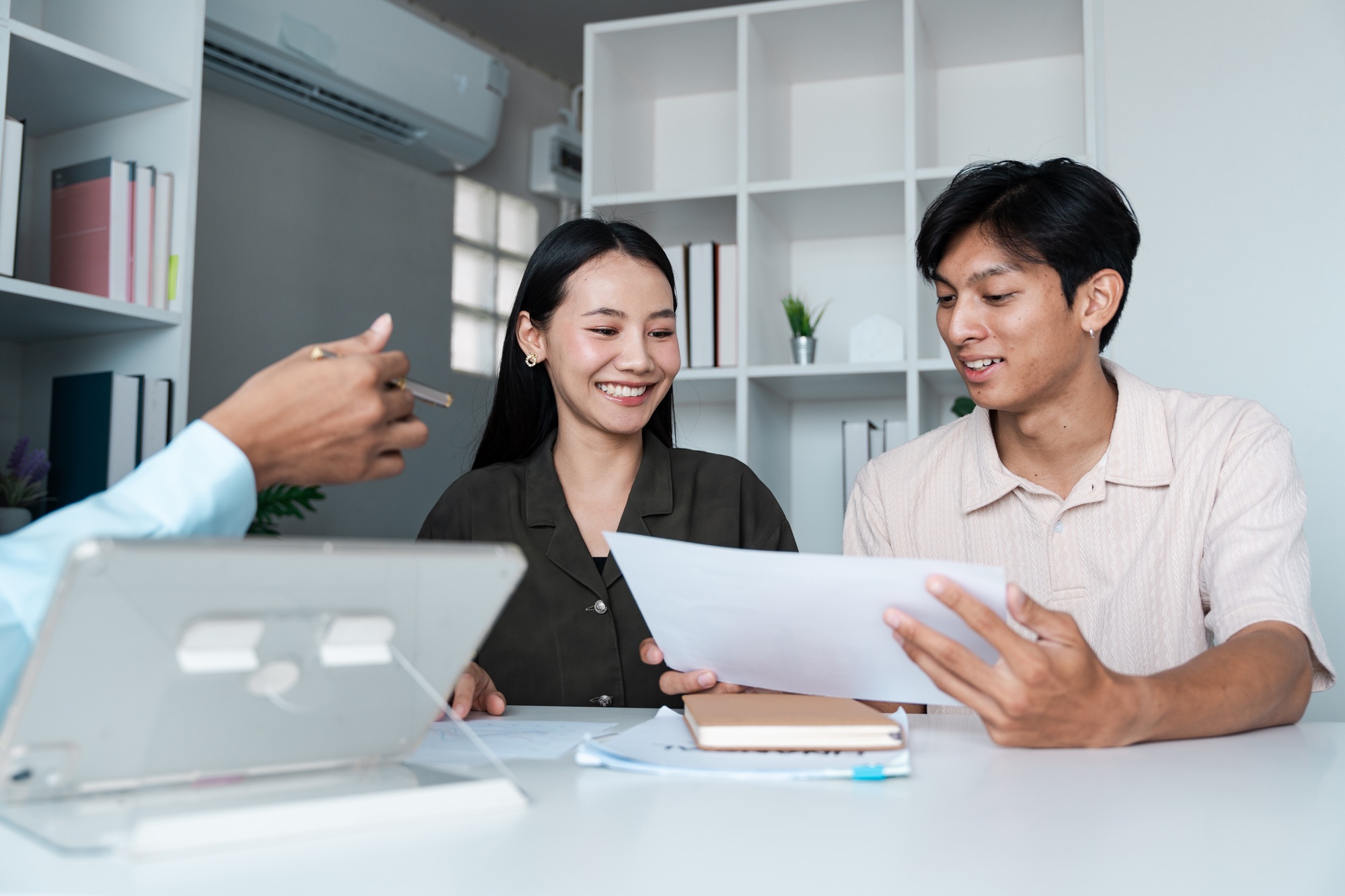 Couple Discussing Investment Plans with Financial Planner in Modern Office Setting